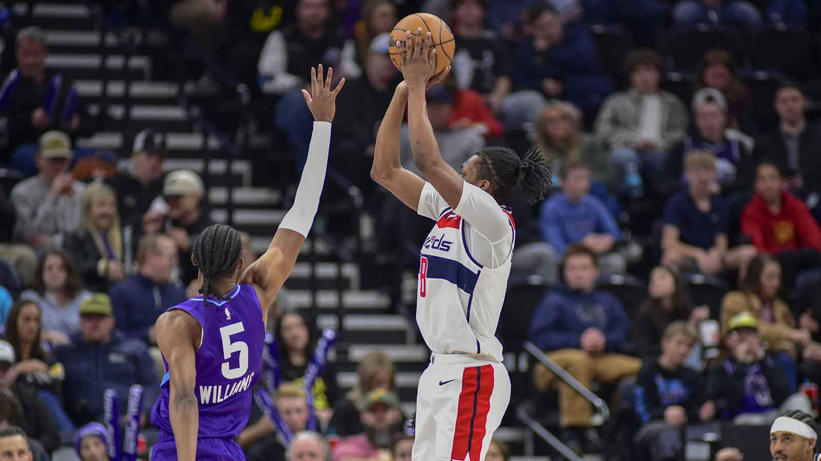 Washington Wizards guard Bub Carrington (8) attempts a three point basket against Utah Jazz forward Cody Williams (5) during the second half at the Delta Center.