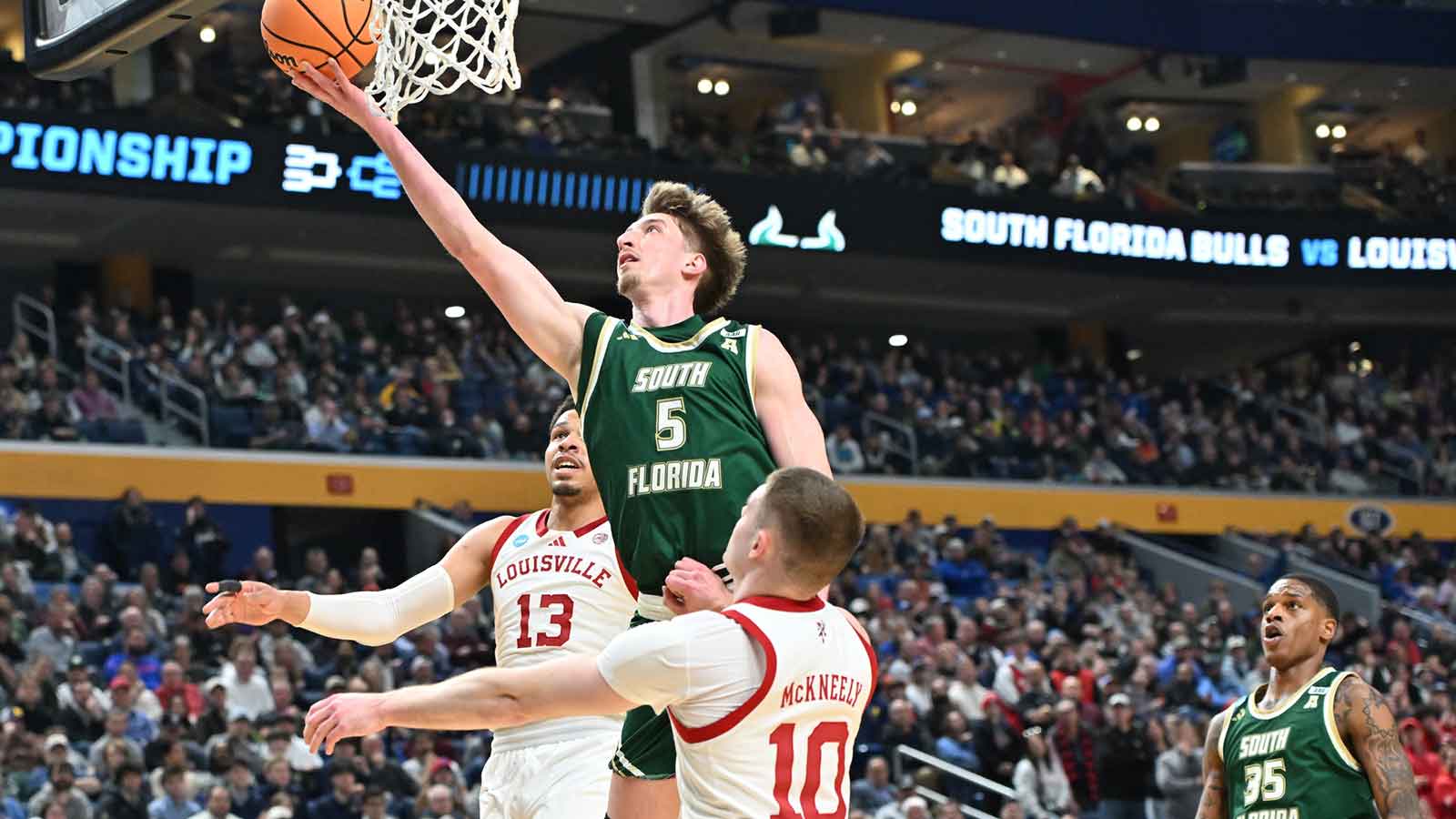 South Florida Bulls guard Joseph Pinion (5) shoots a lay up during the second half against the Louisville Cardinals during a first round game of the men's 2026 NCAA Tournament at Keybank Center.