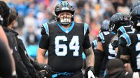 Carolina Panthers center Cade Mays (64) runs on to the field before the game at Bank of America Stadium.