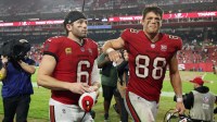 Tampa Bay Buccaneers quarterback Baker Mayfield (6) and tight end Cade Otton (88) leave the field after defeating the Carolina Panthers at Raymond James Stadium.