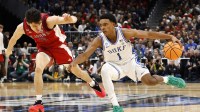 Duke Blue Devils guard Caleb Foster (1) dribbles the ball against St. John's Red Storm guard Dylan Darling (0) in the first half during a Sweet Sixteen game of the East Regional of the men's 2026 NCAA Tournament at Capital One Arena.