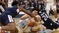 UConn Huskies guard Braylon Mullins (24) forces a jump ball with Duke Blue Devils forward Cameron Boozer (12) in the second half during an Elite Eight game of the East Regional of the men's 2026 NCAA Tournament at Capital One Arena.