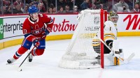 Montreal Canadiens right wing Cole Caufield (13) plays the puck behind Boston Bruins Jeremy Jeremy Swayman (1) net during overtime at Bell Centre.
