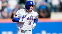 Carson Benge, of the New York Mets rounds the bases after hitting his first MLB home-run, in his first game
