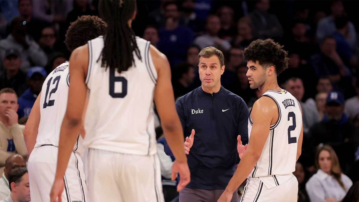 Duke Blue Devils head coach Jon Scheyer talks to Duke Blue Devils forwards Cameron Boozer (12) and Maliq Brown (6) and guard Cayden Boozer (2) during the second half against the Texas Tech Red Raiders at Madison Square Garden.