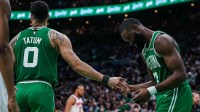 Celtics guard Jaylen Brown (7) reacts after missing a pass from Boston Celtics forward Jayson Tatum (0) against the New York Knicks in the second half during game two of the second round for the 2025 NBA Playoffs at TD Garden with JR Smith in the background
