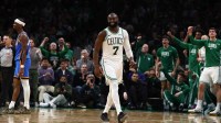 Celtics guard Jaylen Brown smiles after being fouled while making a shot by Oklahoma City Thunder guard Shai Gilgeous-Alexander (2) (left) during the fourth quarter at TD Garden with Thunder's Mark Daigneault in the background