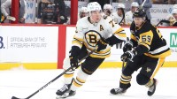 Boston Bruins defenseman Charlie McAvoy (73) handles the puck against Pittsburgh Penguins right wing Egor Chinakhov (59) in overtime at PPG Paints Arena.