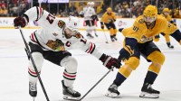 Chicago Blackhawks left wing Nick Foligno (17) and Nashville Predators defenseman Nicolas Hague (41) battle for the puck during the second period at Bridgestone Arena