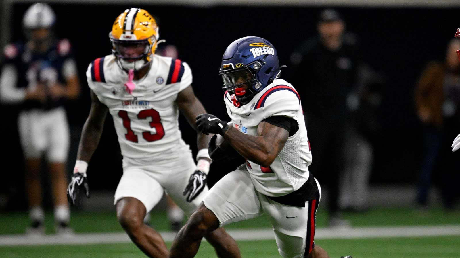 East running back Chip Trayanum (14) runs with the ball against the West during the second half at the Ford Center at the Star. Mandatory Credit: Jerome Miron-Imagn Images
