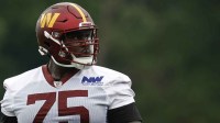 Washington Commanders guard Chris Paul (75) stands on the field during OTA workouts at Commanders Park.