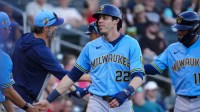 Brewers outfielder Christian Yelich (22) celebrates scoring against the Diamondbacks during a spring training game at Salt River Fields on March 20, 2026.