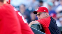 Cincinnati Reds manager Terry Francona (77) looks out to the field from the dugout during a Cactus League game between the Cincinnati Reds and Seattle Mariners at Goodyear Ballpark in Goodyear, Ariz.