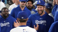 Los Angeles Dodgers pitcher Yoshinobu Yamamoto (18) is congratulated by pitcher Clayton Kershaw (right) at the end of the eighth inning against the Miami Marlins at Dodger Stadium.