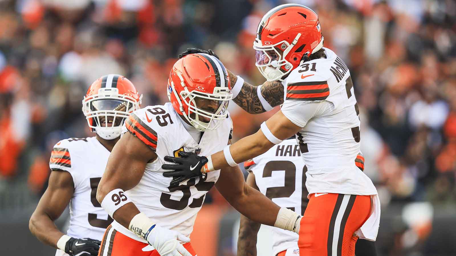 Cleveland Browns defensive end Myles Garrett (95) celebrates with safety Donovan McMillon (31) following a sack against the Cincinnati Bengals during the fourth quarter at Paycor Stadium. The play set a new NFL single season sack record by Garrett.