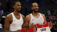 Toronto Raptors center Olivier Sarr (11) poses with his brother, Washington Wizards center Alex Sarr (20) during a jersey swap after their game at Capital One Arena.