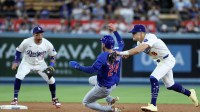 Los Angeles Dodgers second baseman Enrique Hernandez (8) makes an error as he attempts to tag Chicago Cubs right fielder Cody Bellinger (24) during the eighth inning at Dodger Stadium.