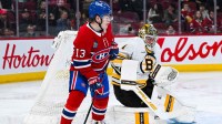 Boston Bruins Jeremy Jeremy Swayman (1) makes a save beside Montreal Canadiens right wing Cole Caufield (13) during the second period at Bell Centre.