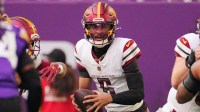 Washington Commanders quarterback Jayden Daniels (5) drops back to pass against the Minnesota Vikings during the first half at U.S. Bank Stadium.