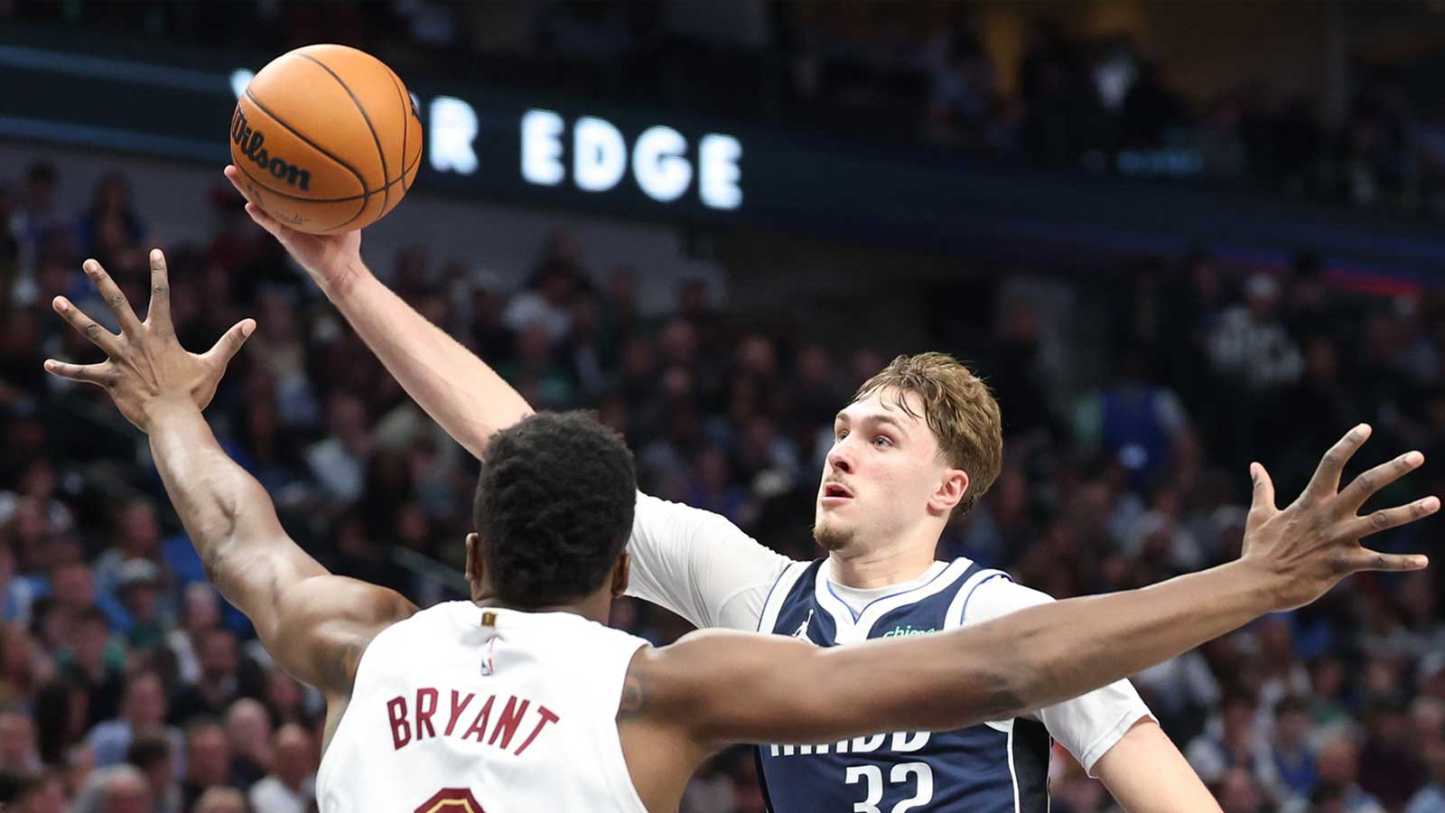 Dallas Mavericks forward Cooper Flagg (32) passes over Cleveland Cavaliers center Thomas Bryant (3) during the second half at American Airlines Center.