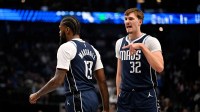 Dallas Mavericks forward Naji Marshall (13) and forward Cooper Flagg (32) look during the game between the Pistons and Mavericks at the American Airlines Center.