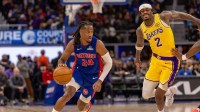Detroit Pistons Daniss Jenkins (24) moves the ball up court next to Los Angeles Lakers Jarred Vanderbilt (2) during the second half at Little Caesars Arena.