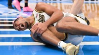 Purdue Boilermakers guard C.J. Cox (0) reacts to an injury during the second half against the Miami Hurricanes during a second round game of the men's 2026 NCAA Tournament at Enterprise Center.