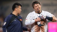 Japan center fielder Seiya Suzuki (51) exits the game after an apparent injury against Venezuela in the first inning during a quarterfinal game of the 2026 World Baseball Classic at loanDepot Park.