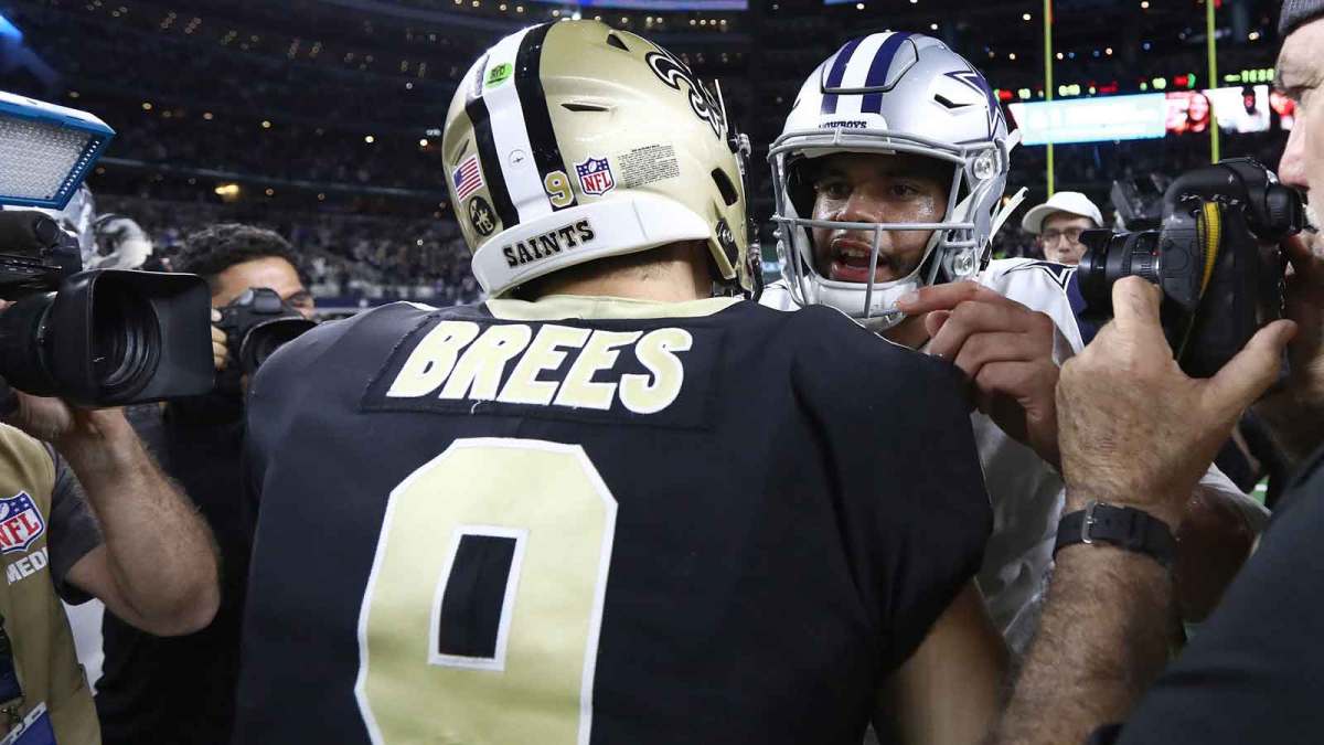 Dallas Cowboys quarterback Dak Prescott (4) meets with New Orleans Saints quarterback Drew Brees (9) after the game at AT&T Stadium.