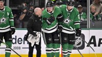 Dallas Stars center Roope Hintz (24) is helped off the ice by left wing Jason Robertson (21) after being injured during the game between the Stars and the Avalanche at American Airlines Center.