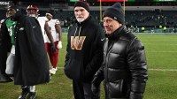 Washington Commanders head coach Dan Quinn and owner Josh Harris on the field after win against the Philadelphia Eagles at Lincoln Financial Field.