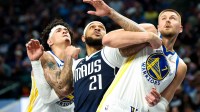 Golden State Warriors forward Gui Santos (15) and Dallas Mavericks forward Daniel Gafford (21) and Golden State Warriors center Kristaps Porzingis (7) go for the ball during the first half at American Airlines Center.