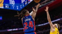 Detroit Pistons Daniss Jenkins (24) shoots a big two point basket late in fourth quarter as Los Angeles Lakers Austin Reaves (15) defends at Little Caesars Arena.