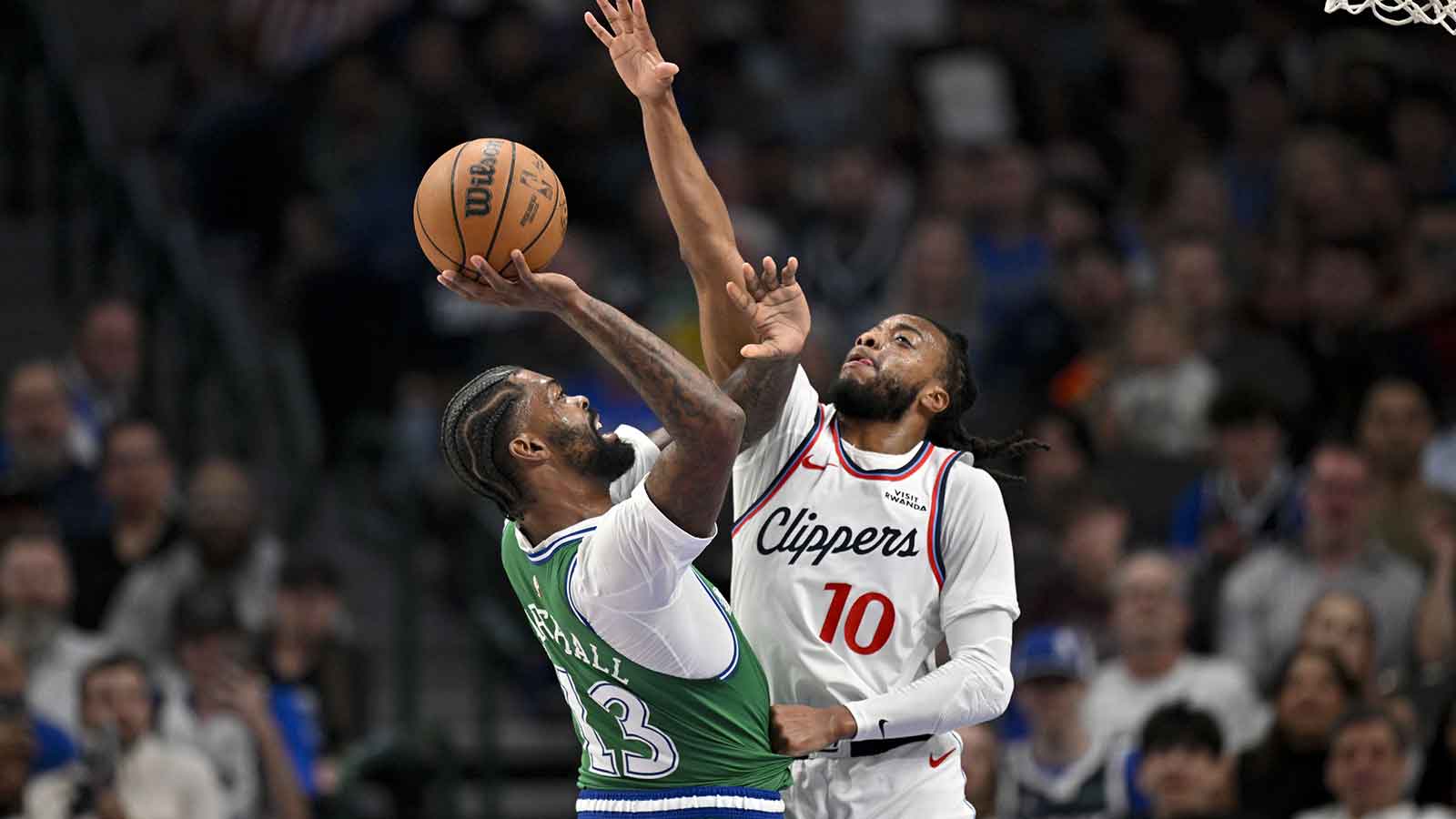 Dallas Mavericks forward Naji Marshall (13) shoots over LA Clippers guard Darius Garland (10) during the first quarter at the American Airlines Center.
