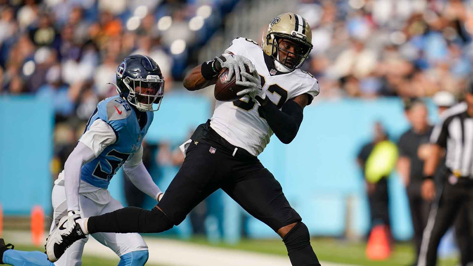 New Orleans Saints tight end Juwan Johnson (83) catches the ball in front of Tennessee Titans cornerback Darrell Baker Jr. (39) during the second quarter at Nissan Stadium.