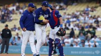 Los Angeles Dodgers manager Dave Roberts (left) taking pitcher Roki Sasaki (middle) out from the game during the first inning against the Los Angeles Angels at Dodger Stadium.