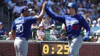Los Angeles Dodgers right fielder Jack Suwinski celebrates with manager Dave Roberts (30) after hitting a three run home run against the Chicago Cubs in the first inning at Sloan Park.