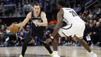 Detroit Pistons forward Duncan Robinson (55) dribbles defended by Brooklyn Nets center Day'ron Sharpe (20) in the second half at Little Caesars Arena.