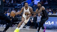 Golden State Warriors guard De'anthony Melton (8) drives past Brooklyn Nets guard Terance Mann (14) during the third quarter at Chase Center.