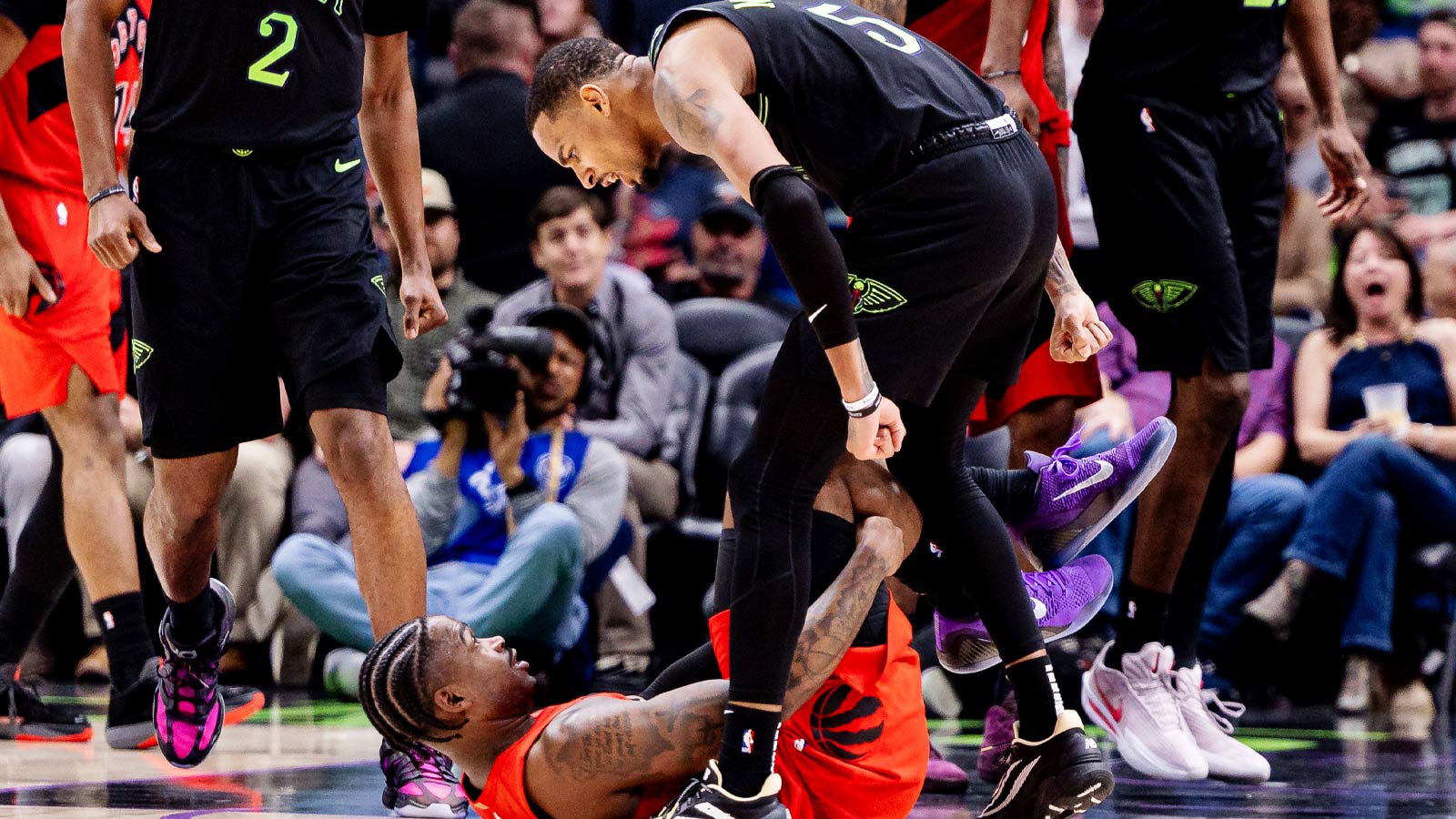 This photo of Pelicans’ Dejounte Murray standing over Jamal Shead after dropping him goes so hard