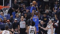 Oklahoma City Thunder guard Shai Gilgeous-Alexander (2) shoots against the Denver Nuggets during the first quarter at Paycom Center.