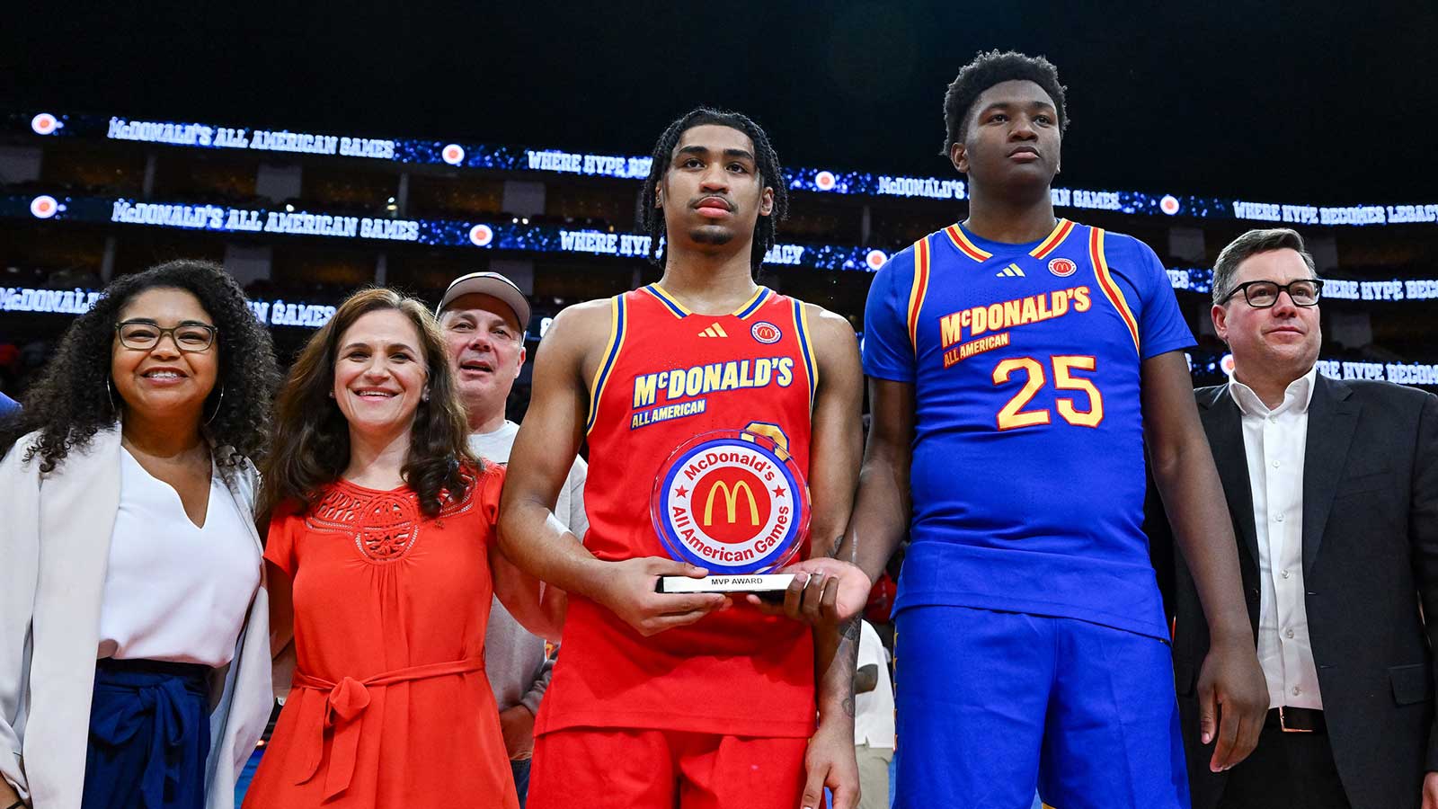 McDonald's All American West guard Dylan Harper (2) and McDonald's All American East center Derik Queen (25) are presented with the MVP trophy after the game at Toyota Center.