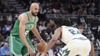 Boston Celtics guard Derrick White (9) brings the ball up the court against Milwaukee Bucks guard Cam Thomas (24) in the second half at Fiserv Forum.