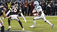 Detroit Lions running back Jahmyr Gibbs (0) runs with the ball for a touchdown against the Chicago Bears during the first half at Soldier Field.