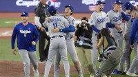 Los Angeles Dodgers pitcher Roki Sasaki (11) and two-way player Shohei Ohtani (17) celebrate after defeating the Toronto Blue Jays in game seven of the 2025 MLB World Series at Rogers Centre.