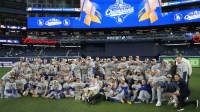 The Los Angeles Dodgers pose for a group photo on the field after defeating the Toronto Blue Jays in game seven of the 2025 MLB World Series at Rogers Centre.