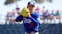 Los Angeles Dodgers starting pitcher Roki Sasaki (11) pitches against the Cleveland Guardians during the first inning at Goodyear Ballpark.