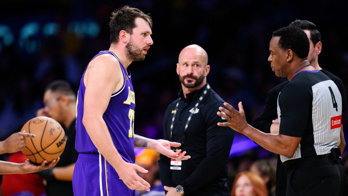 Los Angeles Lakers guard Luka Doncic (77) talks to referee Sean Wright (4) during the second half against the Brooklyn Nets at Crypto.com Arena.