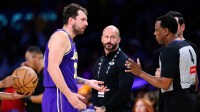 Los Angeles Lakers guard Luka Doncic (77) talks to referee Sean Wright (4) during the second half against the Brooklyn Nets at Crypto.com Arena.