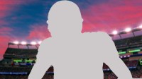 Silhouette of New England Patriots quarterback Drake Maye, who now has a bald hairstyle for charity, with Gillette Stadium background.